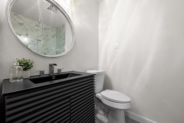 7002 Teaberry Dr, Austin, TX 78745 - bathroom with vanity, a textured wall, and a marble finish shower