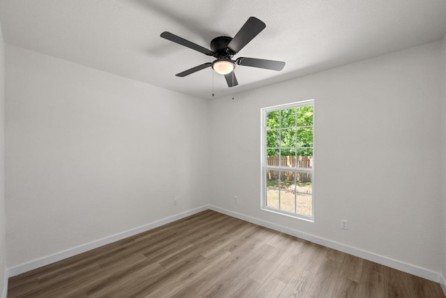 7002 Teaberry Dr, Austin, TX 78745 - empty room with wood finished floors and ceiling fan