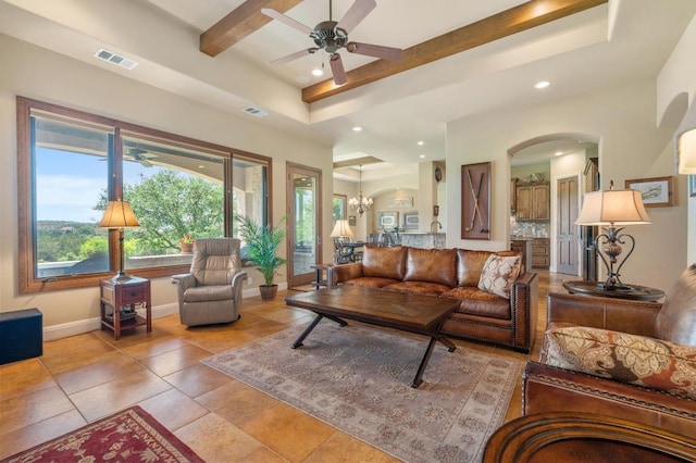 living room featuring arched walkways, recessed lighting, ceiling fan, baseboards, and beamed ceiling