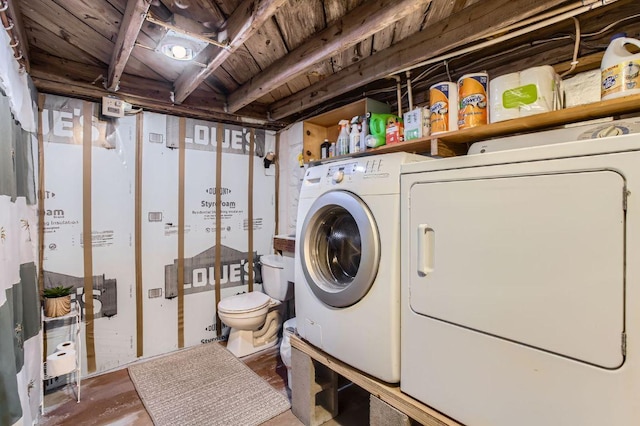 washroom with washing machine and dryer and wooden ceiling