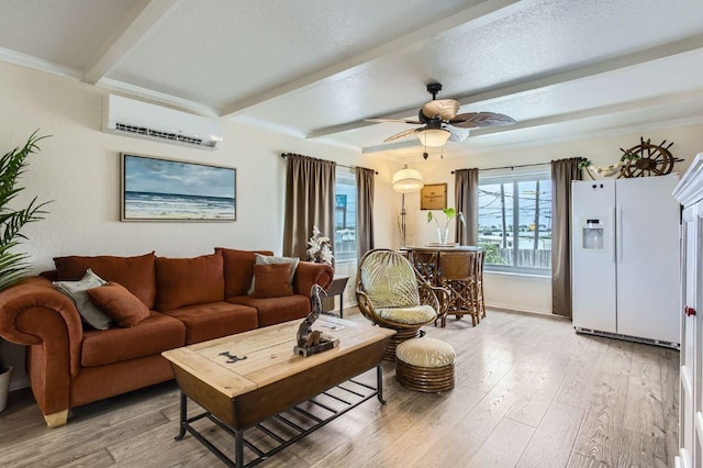 living area with a wall unit AC, beam ceiling, light wood-type flooring, and a ceiling fan