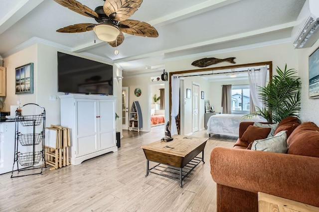 living room featuring light wood finished floors, a ceiling fan, ornamental molding, a wall unit AC, and beamed ceiling