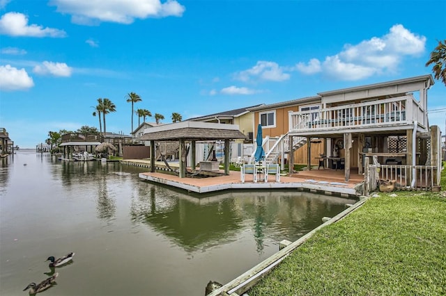 back of property featuring stairway, a deck with water view, and a lawn