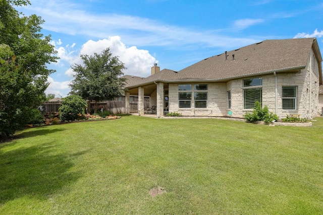 417 Freeman Park Pl, Round Rock, TX 78665 - back of house featuring stone siding, a chimney, a shingled roof, and a patio