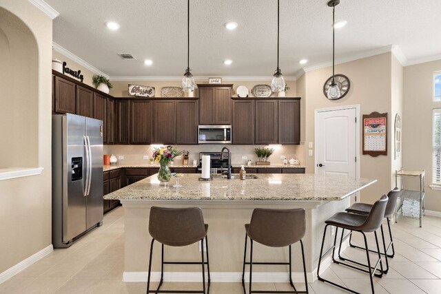 417 Freeman Park Pl, Round Rock, TX 78665 - kitchen with appliances with stainless steel finishes, a sink, baseboards, dark brown cabinets, and recessed lighting