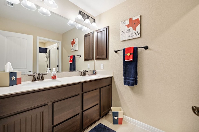 417 Freeman Park Pl, Round Rock, TX 78665 - full bath with double vanity, tile patterned flooring, baseboards, and a textured wall