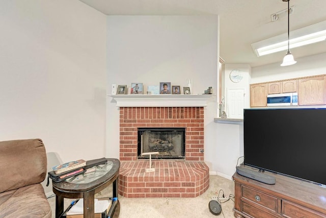 living area with carpet and a fireplace