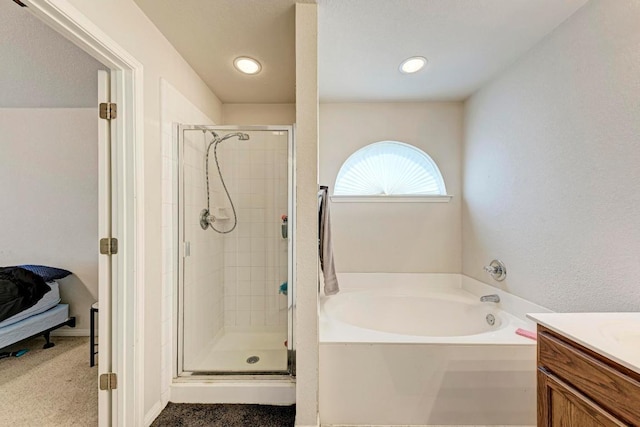full bathroom featuring a stall shower, a bath, vanity, and recessed lighting