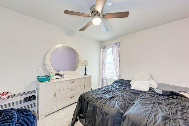 bedroom with light carpet and a ceiling fan
