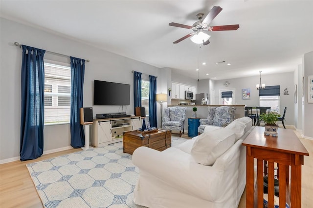 360 Waterloo Dr, Kyle, TX 78640 - living area featuring a ceiling fan, baseboards, a chandelier, light wood-type flooring, and recessed lighting
