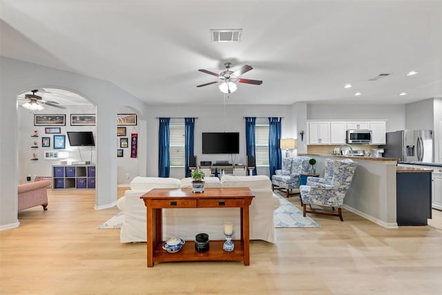 360 Waterloo Dr, Kyle, TX 78640 - living area with ceiling fan, light wood finished floors, baseboards, recessed lighting, and arched walkways