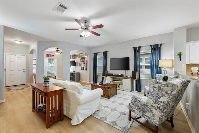360 Waterloo Dr, Kyle, TX 78640 - living area with ceiling fan, arched walkways, light wood-style flooring, and baseboards