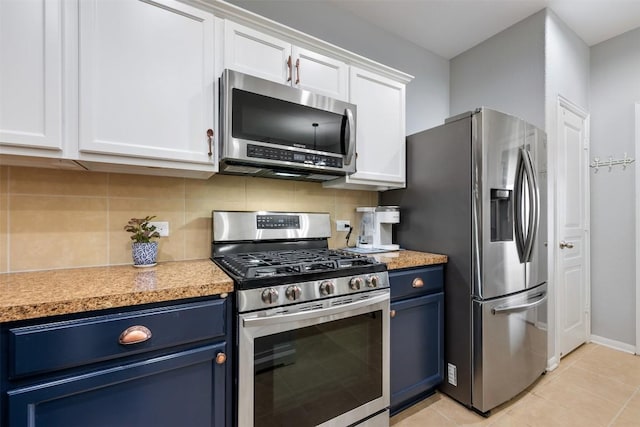 360 Waterloo Dr, Kyle, TX 78640 - kitchen featuring stainless steel appliances, blue cabinets, light countertops, and tasteful backsplash