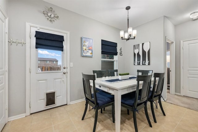 360 Waterloo Dr, Kyle, TX 78640 - dining area with a chandelier, light tile patterned floors, and baseboards