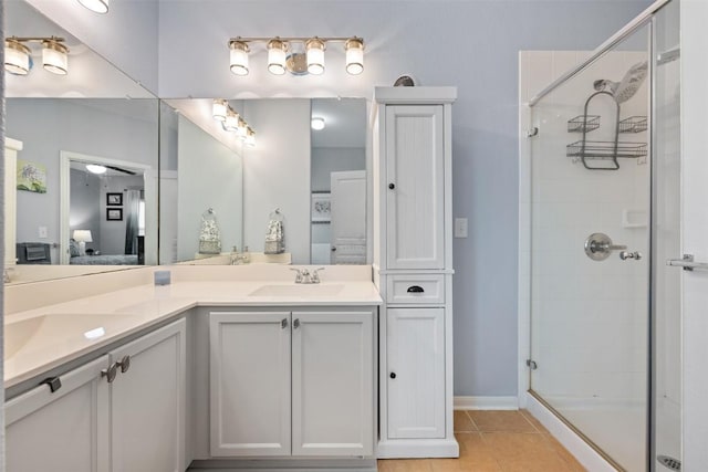 360 Waterloo Dr, Kyle, TX 78640 - bathroom with ensuite bathroom, a shower stall, double vanity, and tile patterned floors