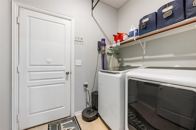 360 Waterloo Dr, Kyle, TX 78640 - laundry room with independent washer and dryer, light tile patterned flooring, and baseboards