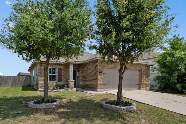 360 Waterloo Dr, Kyle, TX 78640 - view of front of home featuring an attached garage, driveway, and brick siding