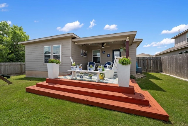 rear view of property featuring a ceiling fan, a wooden deck, and outdoor dining area