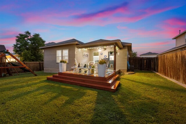 360 Waterloo Dr, Kyle, TX 78640 - back of house at dusk with a deck