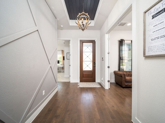 20513 Christie Marie Ln, Pflugerville, TX 78660 - entryway with a chandelier, dark wood finished floors, baseboards, and a raised ceiling