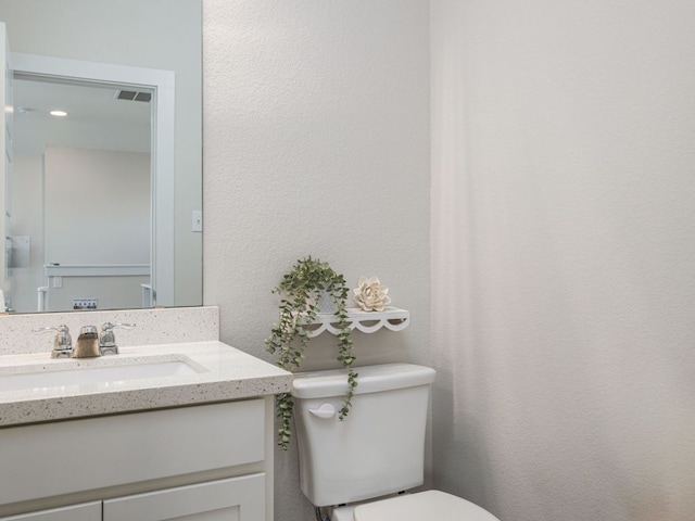 20513 Christie Marie Ln, Pflugerville, TX 78660 - half bathroom with toilet, vanity, and a textured wall