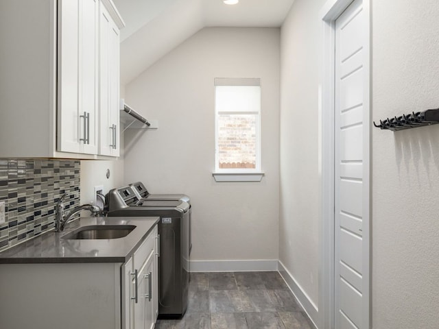 20513 Christie Marie Ln, Pflugerville, TX 78660 - laundry area featuring cabinet space, washing machine and dryer, baseboards, and dark stone finish floors