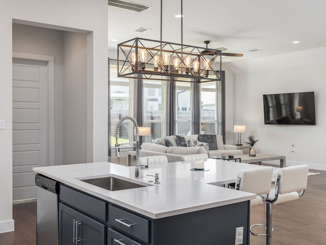 20513 Christie Marie Ln, Pflugerville, TX 78660 - kitchen with open floor plan, a sink, an island with sink, stainless steel dishwasher, and light countertops