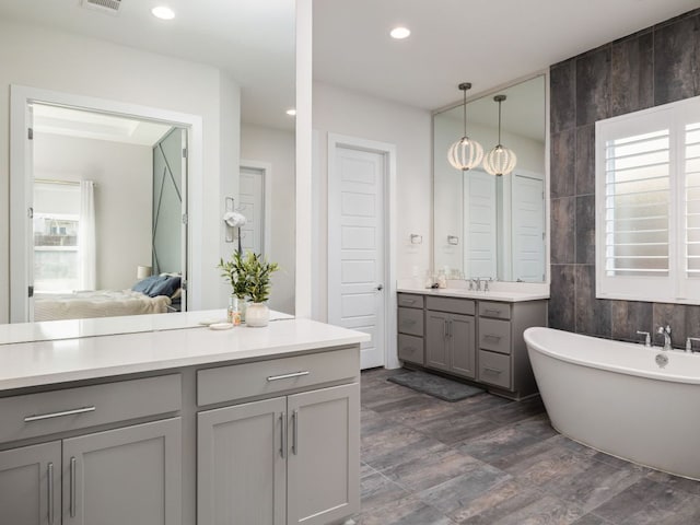 20513 Christie Marie Ln, Pflugerville, TX 78660 - ensuite bathroom with a soaking tub, vanity, and recessed lighting