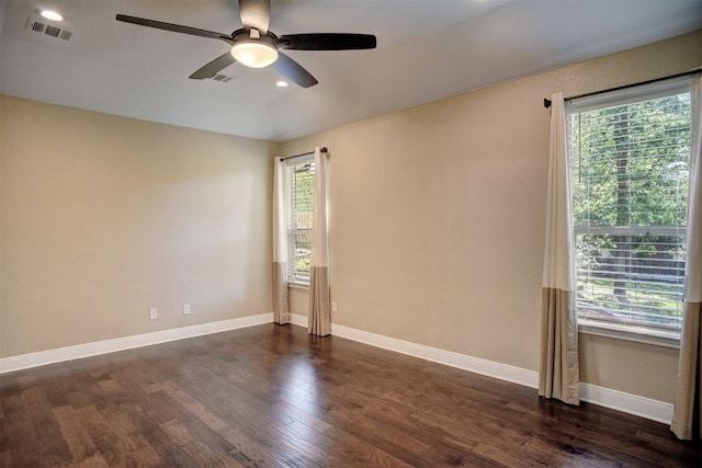 empty room featuring ceiling fan, dark wood finished floors, baseboards, and recessed lighting