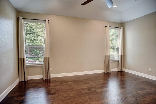 empty room featuring a ceiling fan, hardwood / wood-style floors, and baseboards
