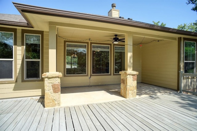 wooden terrace featuring a patio area and a ceiling fan