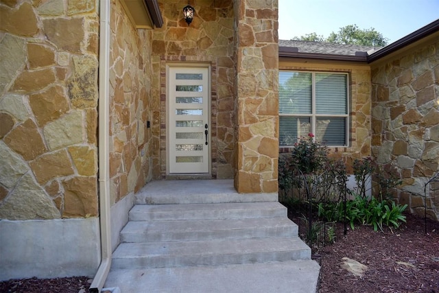 entrance to property with stone siding