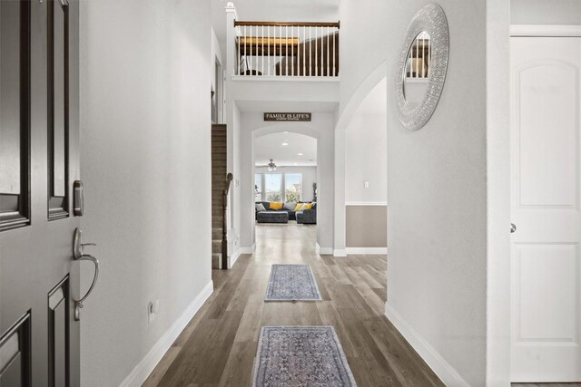 7404 Leonardo Dr, Round Rock, TX 78665 - hall with wood finished floors, baseboards, and arched walkways