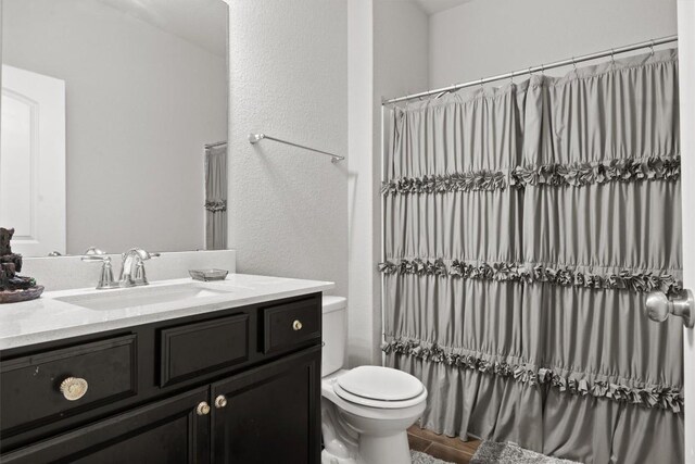 7404 Leonardo Dr, Round Rock, TX 78665 - full bath with vanity, toilet, and a textured wall