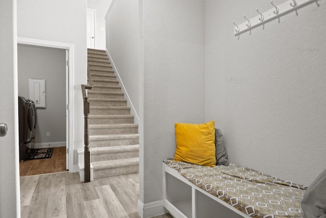 mudroom featuring wood finished floors, washer / dryer, and baseboards