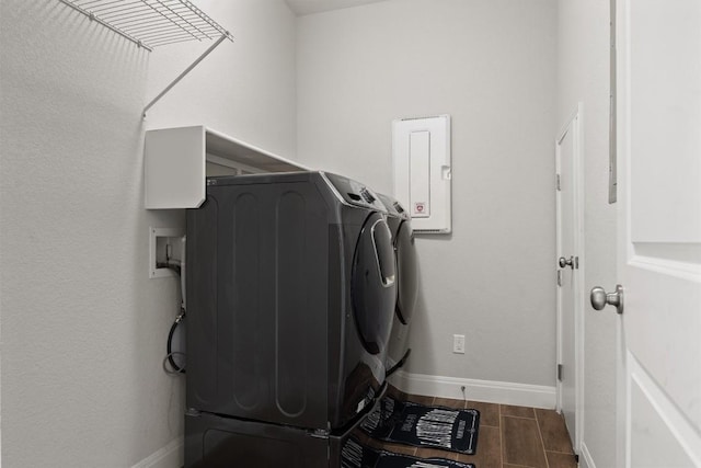 laundry room with washer and dryer, baseboards, and wood finish floors