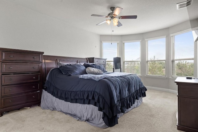 bedroom with light colored carpet, a ceiling fan, and baseboards
