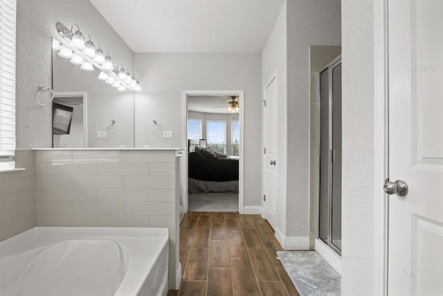 full bath with ensuite bathroom, a shower stall, wood finished floors, a bath, and ceiling fan