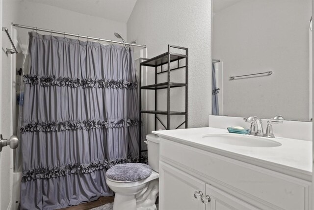 7404 Leonardo Dr, Round Rock, TX 78665 - full bath with vanity, toilet, a textured wall, and shower / bath combo