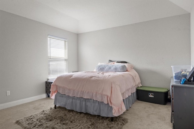 bedroom with light carpet and baseboards