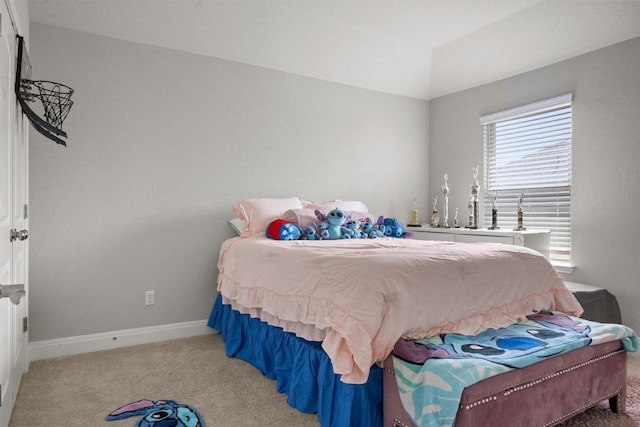 bedroom featuring light carpet and baseboards