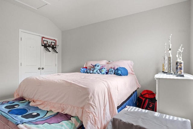 bedroom with lofted ceiling and a closet