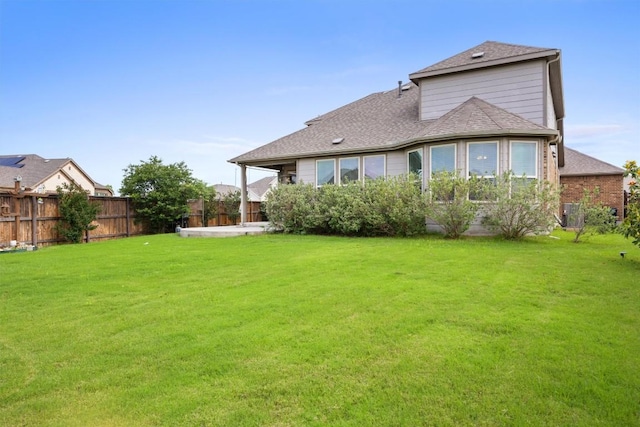 rear view of house with a shingled roof