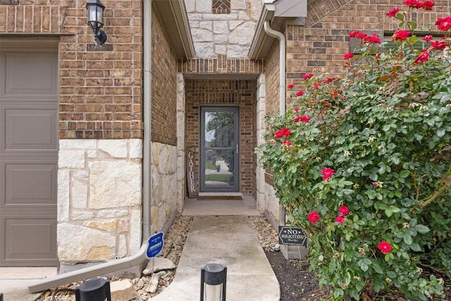 7404 Leonardo Dr, Round Rock, TX 78665 - entrance to property featuring stone siding, a garage, and brick siding