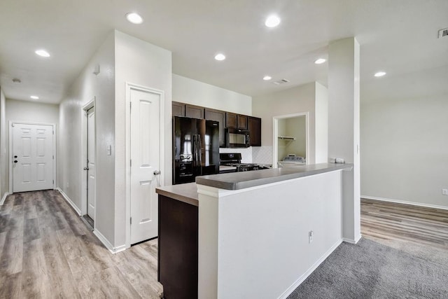 kitchen with black appliances, dark brown cabinets, baseboards, light wood-type flooring, and recessed lighting