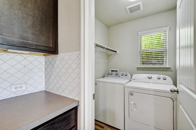 clothes washing area with independent washer and dryer