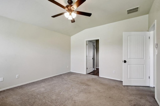 unfurnished bedroom featuring carpet, baseboards, lofted ceiling, and ceiling fan