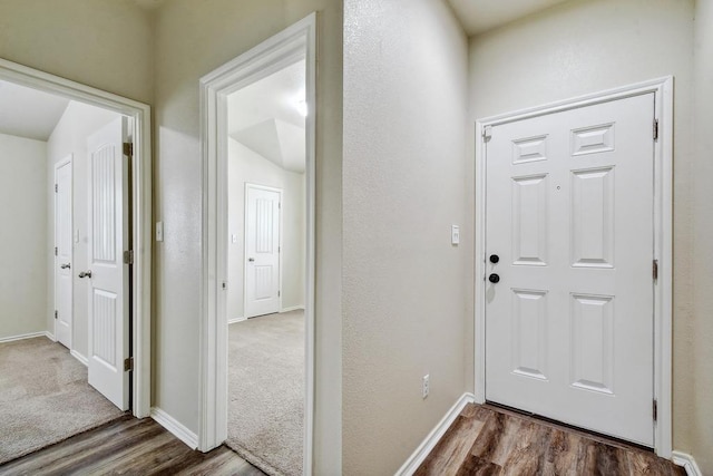 foyer entrance featuring wood finished floors and baseboards