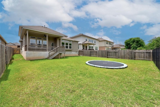257 Falling Star Ln, Georgetown, TX 78628 - back of property featuring a trampoline, a ceiling fan, and stairway
