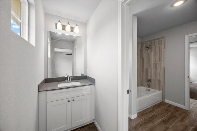 257 Falling Star Ln, Georgetown, TX 78628 - bathroom with  shower combination, vanity, baseboards, and wood tiled floors